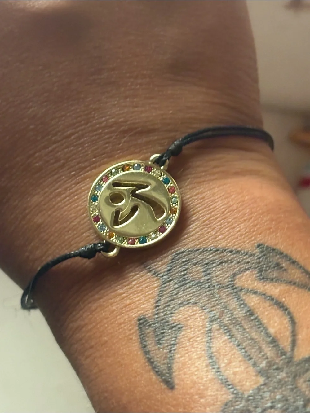 Zumba Fitness Gold Om Pendant Bracelet with Multicolor Crystals and Black Cord